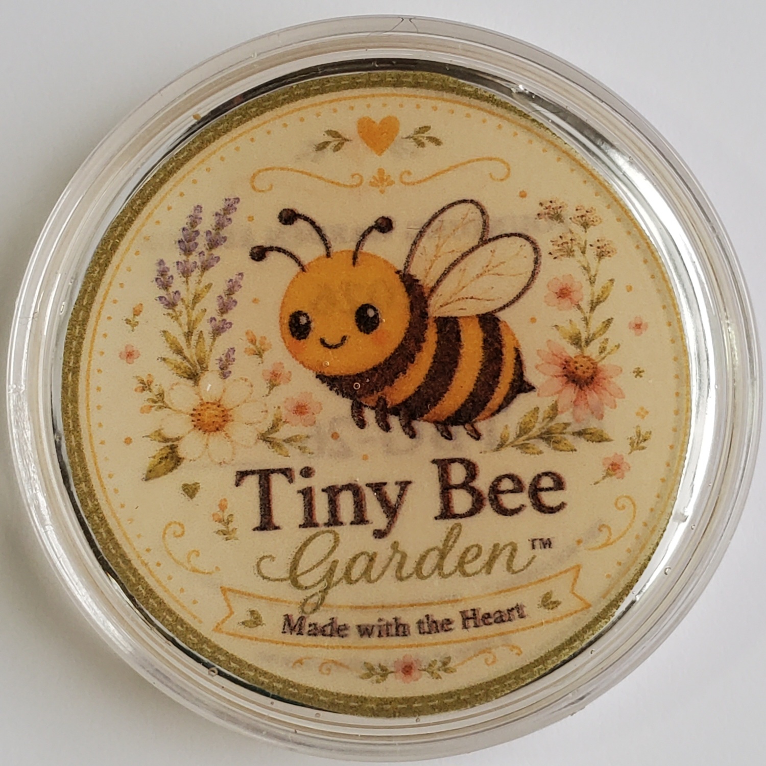 Front of the Tiny Bee Garden token with bee and flowers