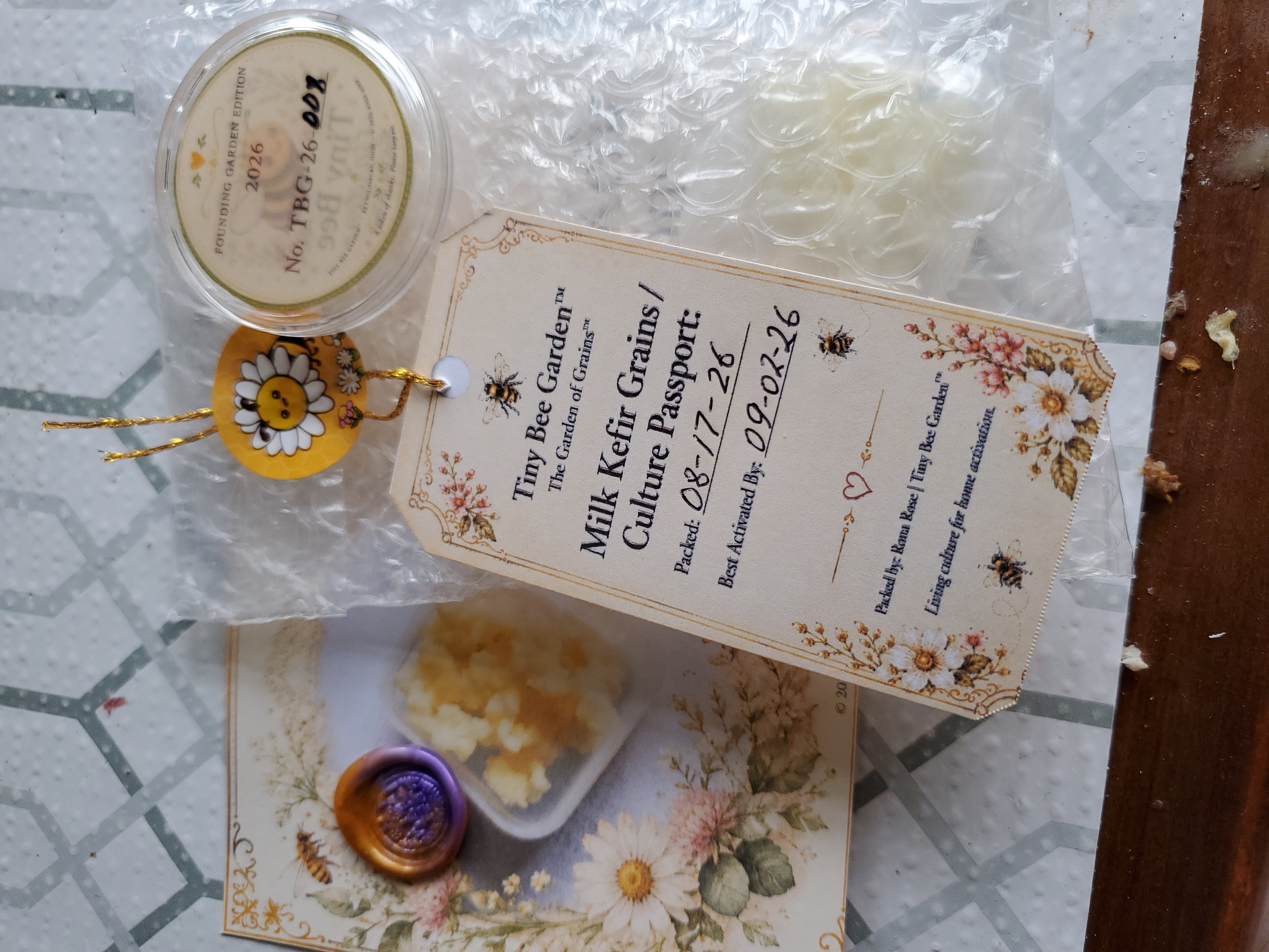 Inside packaging: passport for the grains, collectible wax stamped card and collectible token